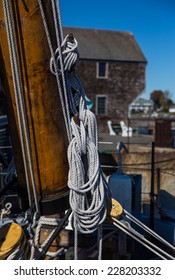 Mast with ropes and pulleys on boat.