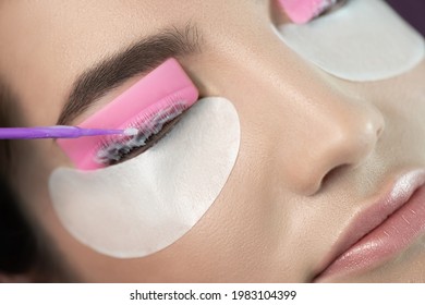 Master Applies Care Perm Cream To Eyelashes. Close-up Of Beauty Model's Face During Lash Lift Laminating Procedure. Eyelash Care Treatment: Eyelash Lifting And Curling, Lash Lamination And Extension.