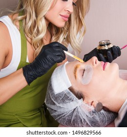 The Master Apply Scrub On Eyebrows With Wooden Stick For Prepare Them To Dyeing.