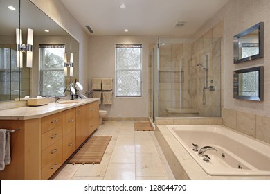 Master Bath In Luxury Home With Oak Wood Cabinetry