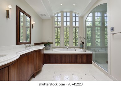 Master Bath In Luxury Home With Wood Cabinetry