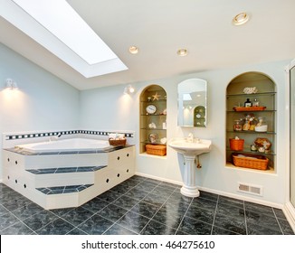 Master Bathroom With Blue Marble Tile Floor, Corner Bath Tub With Stairs And Tile Trim, Vintage Washbasin Stand And Built In Shelves With Some Decor. Northwest , USA