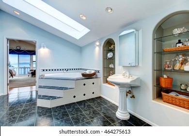 Master Bathroom With Blue Marble Tile Floor, Corner Bath Tub With Stairs And Tile Trim, Vintage Washbasin Stand And Built In Shelves With Some Decor. Northwest , USA