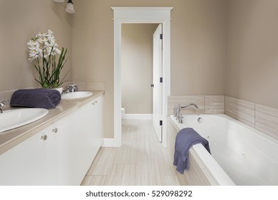 Master Bathroom With Double Vanity And Bathtub In New Luxury Home