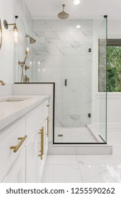 Master Bathroom In New Luxury Home: Features Elegant Shower With Glass Door, Multiple Shower Heads, Sink With Vanity, And Elegant Tile Floor