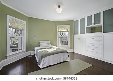 Master Bedroom With Green Walls And Dark Wood Flooring