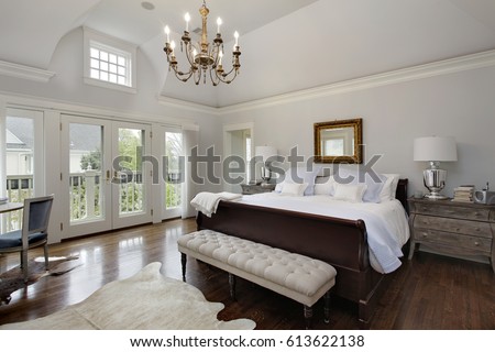 Master bedroom in luxury home with doors to balcony.