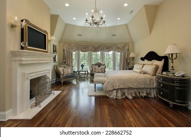 Master Bedroom In Luxury Home With Fireplace