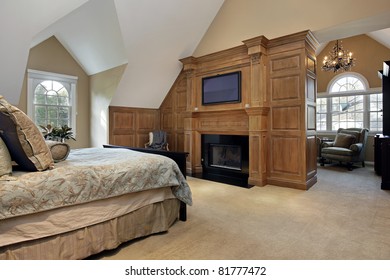 Master Bedroom In Luxury Home With Fireplace