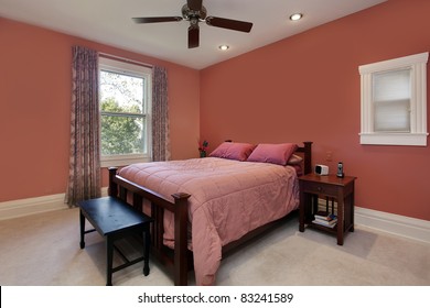 Master Bedroom With Peach Colored Walls And Ceiling Fan