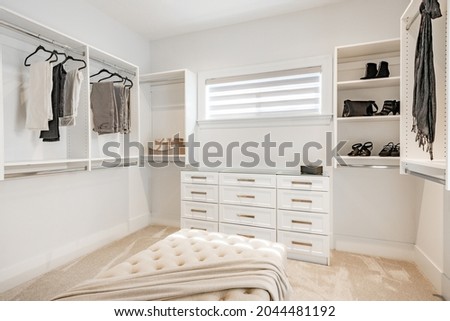Master bedroom with walk in closet and large ensuite bathroom tub glass shower staged closet 
