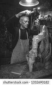 Master Carpenter 50 - 55 Years Old Creates Wooden Sculpture In The Workshop, Black And White Photography