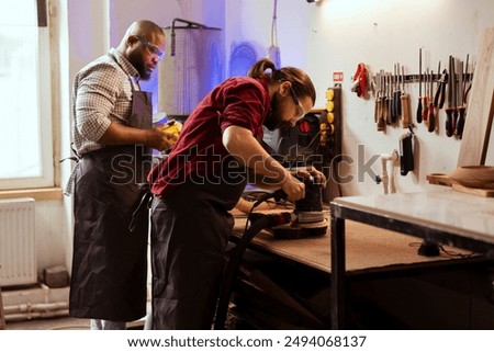Similar – Image, Stock Photo Master carpenter and apprentice using a clamp for wood gluing in a workshop