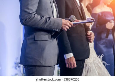 Master Of Ceremonies With Microphone On Stage