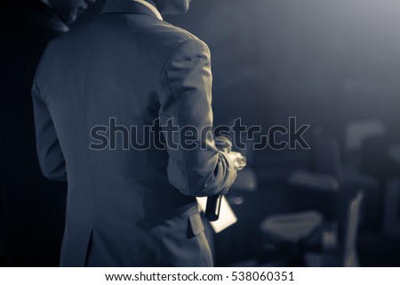 Master of ceremonies with microphone on stage