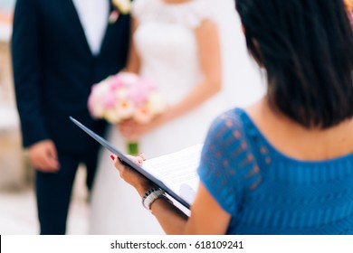 The Master Of Ceremonies At A Wedding In Montenegro. With A Folder Of Documents In Hand.