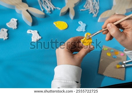 Master class of coloring Creator is using white air dry clay for making decor to EASTER holiday. Creating hobby recreation activity that involves fingers. DIY crafting