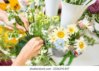 Master class on making bouquets. Spring bouquet in wicker basket. Learning flower arranging, making beautiful bouquets with your own hands - Powered by Shutterstock