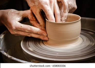 Master class on modeling of clay on a potter's wheel In the pottery workshop - Shutterstock ID 658003336