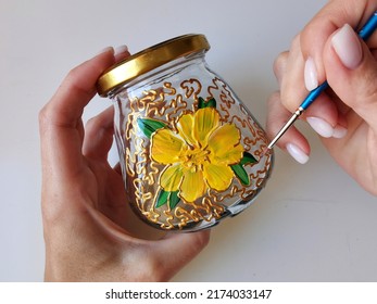 Master class on stained glass painting on a small ceramic jar with a brush, drawing school. Hobbies for women, housewives, children. Flower pattern, gold ornament, handmade