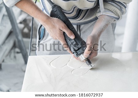 The master engraves the tombstone. Stone processing