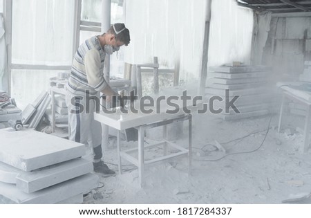 The master engraves the tombstone. Stone processing