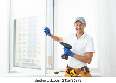 Master in gloves adjusting pvc windows with screwdriver closeup. Installation of plastic windows repair and maintenance concept.