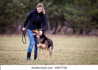 Master and her obedient (German shepherd) dog - Powered by Shutterstock