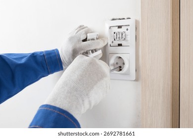 The master installs the light switch and socket, close-up