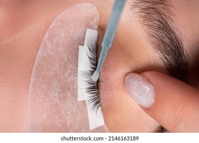 master lash maker performs eyelash degreasing close-up. Eyelash extension procedure. Microbrush