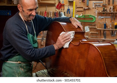 The master luthier builds a double bass in his workshop