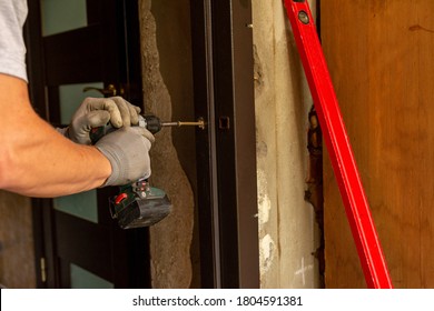 The Master Mounts A Metal Door Frame, Drills Holes In The Box And The Wall For Mounting.