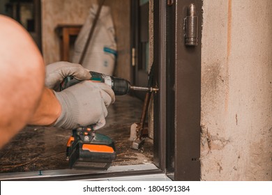 The Master Mounts A Metal Door Frame, Drills Holes In The Box And The Wall For Mounting.