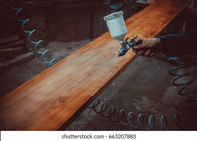 Master Painter In A Factory - Industrial Painting  Wood With Spray Gun.