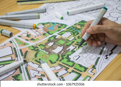 Master Plan Of Urban Landscape Design Or Urban Architecture Drawing By Man's Hand With Drawing Tools , Color Markers, Scale Rulers On The Table, Selective Focus  