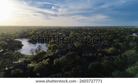 Master planned community to horizontal line, lush green upscale gated community in unincorporated area northwestern Harris County, Houston, Texas, row of expensive mansion homes pools, aerial. USA