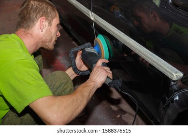 The Master Polishes The Car With A Grinder With Paste. Car Care.