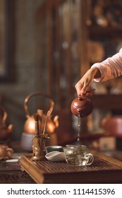 Master pouring tea from a teapot close-up