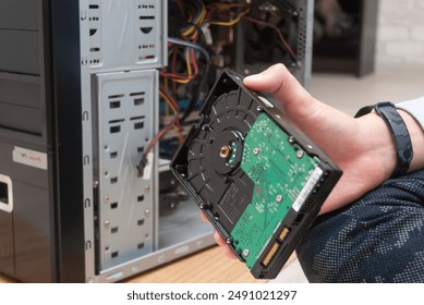 The master repairs the computer system unit, replacing the hard drive.