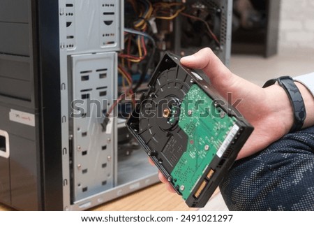 The master repairs the computer system unit, replacing the hard drive.