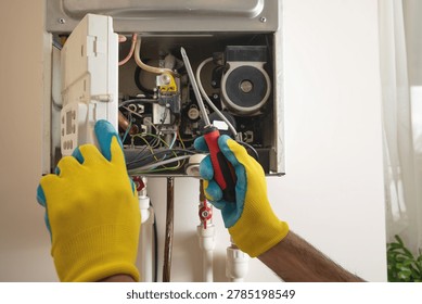 Master repairs a heating system in apartment.