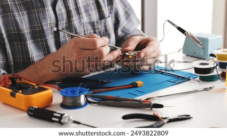 Master Repairs Microchip In Repair Workshop