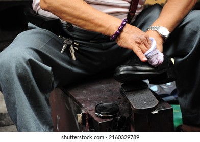 The Master Of The Roadside Shoe Repair Shop Is Polishing Shoes