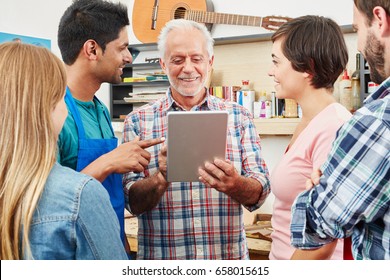 Master of small business with tablet and his team as sign of innovation - Powered by Shutterstock