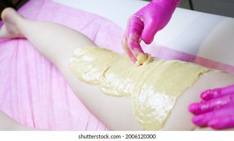 The Master Of Sugar Hair Removal Applies Sugar Paste To The Back Of The Thigh