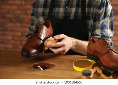 Master taking care of shoes in his workshop, closeup - Powered by Shutterstock