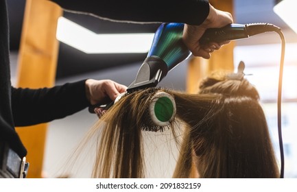 Master Woman Hairdresser Dries The Girl's Hair With A Hairdryer And Combs After Washing In The Beauty Salon.