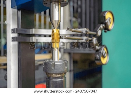 The master worker checks the CNC cutting tool at the centers for runout using indicators.