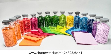 Masterbatch variations in glass bottles with chips, polymer carrying pigment, isolated on white background, space for text, suitable for product catalog design of industrial plastic company profile