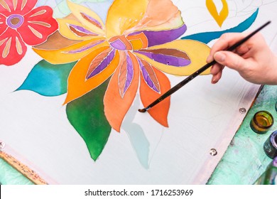 Master-class Of Batik Coloring - Painter Draws Floral Pattern On White Silk Canvas On Wooden Frame In Cold Contour Batik Technique